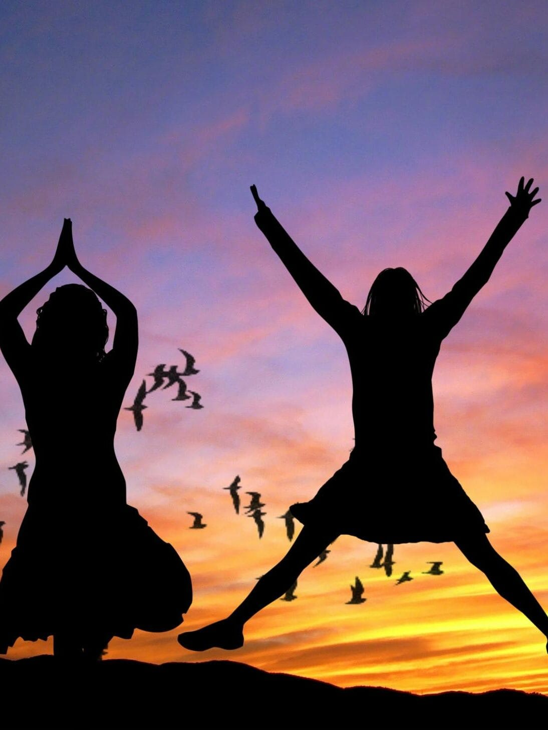 Silhouette of 4 Women With the Background of Birds Flying Under Yellow and Grey Sky