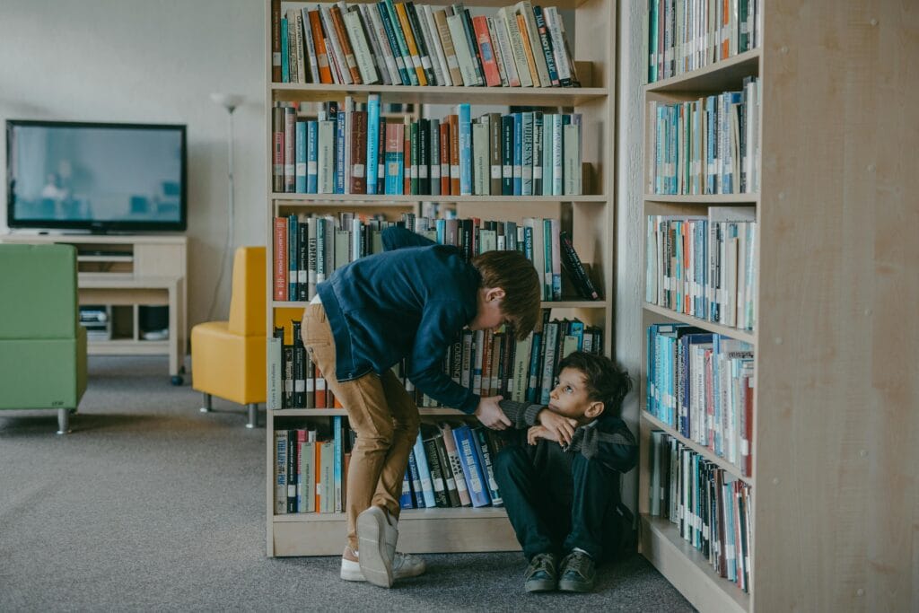 A child bullies another student in a school library, highlighting social issues.