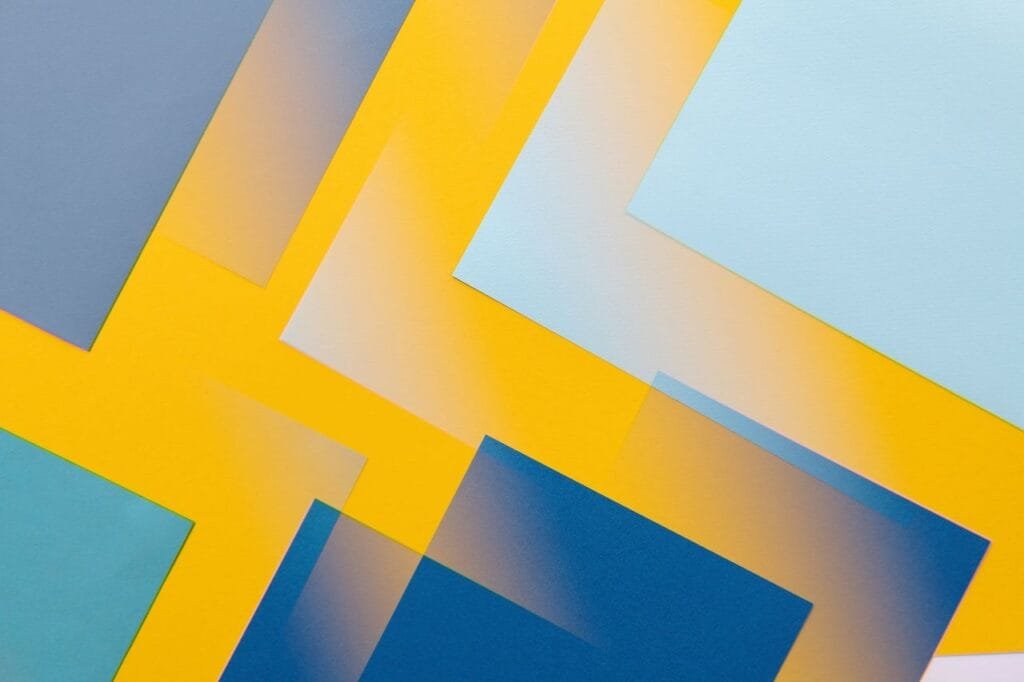 Vibrant abstract geometric pattern featuring overlapping blue and yellow rectangles.